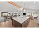Spacious open-concept kitchen with large center island, stainless appliances and dining area at 3303 Wolfensberger Rd, Sedalia, CO 80135