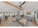 Open-concept living room features dining area, kitchen and outdoor views, perfect for gathering and entertaining at 3303 Wolfensberger Rd, Sedalia, CO 80135