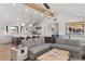 Open-concept living room features kitchen, dining area, and unique decor with outdoor views to surrounding land at 3303 Wolfensberger Rd, Sedalia, CO 80135