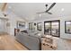Bright living room features vaulted ceilings, a ceiling fan, and a sliding door to the home's deck and outdoor views at 3303 Wolfensberger Rd, Sedalia, CO 80135