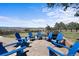 Outdoor patio with blue Adirondack chairs and breathtaking views at 3303 Wolfensberger Rd, Sedalia, CO 80135