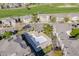 Overhead shot of the community pool amidst townhomes, featuring golf course views and lush landscaping at 13025 Grant Cir # A, Thornton, CO 80241