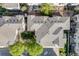 An aerial view showcasing the townhouse community layout with well-maintained landscaping and roof lines at 13025 Grant Cir # A, Thornton, CO 80241