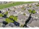 An aerial view of the community featuring lush greenery, a golf course, and well-maintained townhomes at 13025 Grant Cir # A, Thornton, CO 80241