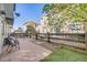 View of the back yard with wood fence, small patio area and chairs, and low maintenance landscaping at 13025 Grant Cir # A, Thornton, CO 80241