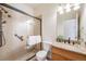 Bathroom featuring a tiled walk-in shower with glass door and a granite vanity with sink at 13025 Grant Cir # A, Thornton, CO 80241