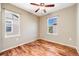 An additional bedroom showcasing hardwood floors and windows providing natural light at 13025 Grant Cir # A, Thornton, CO 80241