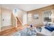 Inviting entryway features gleaming hardwood floors, a staircase, and natural light streaming through a window at 13025 Grant Cir # A, Thornton, CO 80241