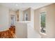 Upstairs hallway with natural light from windows and hardwood flooring at 13025 Grant Cir # A, Thornton, CO 80241