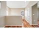Open upstairs hallway with hardwood floors, neutral walls, and natural light from a window at 13025 Grant Cir # A, Thornton, CO 80241
