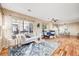 This inviting living room features a fireplace, hardwood floors, large windows, and an open floor plan at 13025 Grant Cir # A, Thornton, CO 80241