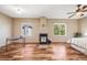 The main bedroom features a fireplace, ceiling fan, windows providing natural light and hardwood floors at 13025 Grant Cir # A, Thornton, CO 80241