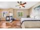 The main bedroom features a fireplace, ceiling fan, windows providing natural light and hardwood floors at 13025 Grant Cir # A, Thornton, CO 80241