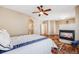 View of a main bedroom that includes a fireplace, ceiling fan, ensuite bathroom and hardwood floors at 13025 Grant Cir # A, Thornton, CO 80241