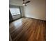 Bright bedroom featuring a window with blinds and laminate wood flooring at 3923 S Idalia St, Aurora, CO 80013