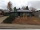 Charming single-story house with green siding and solar panels at 3923 S Idalia St, Aurora, CO 80013