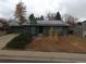 Charming green single-story home featuring solar panels and an attached garage at 3923 S Idalia St, Aurora, CO 80013