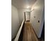 Bright hallway featuring modern wood floors, fresh paint, and a convenient closet at 3923 S Idalia St, Aurora, CO 80013