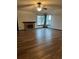 Bright living room featuring laminate wood flooring, fireplace, and large windows at 3923 S Idalia St, Aurora, CO 80013