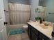 Clean bathroom with a tub and dark vanity at 11105 E Alameda Ave # 202, Aurora, CO 80012