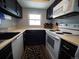 Galley kitchen with white appliances and dark cabinets at 11105 E Alameda Ave # 202, Aurora, CO 80012