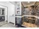 Stylish bathroom features modern tile work, glass shower, sleek mirror and vanity with storage at 300 W 11Th Ave # 15C, Denver, CO 80204