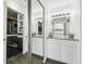 This bathroom has a modern sink, cabinets, lighting, and features a glass enclosed shower with black tile at 300 W 11Th Ave # 15C, Denver, CO 80204