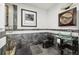 Unique powder room features designer tile work, glass vessel sink, modern fixtures, and glass shower at 300 W 11Th Ave # 15C, Denver, CO 80204