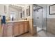 Well-lit bathroom featuring a glass enclosed shower, vanity, neutral tones, and tile accents at 300 W 11Th Ave # 15C, Denver, CO 80204