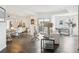 Spacious living area with a dining area, hardwood floors, modern decor, and a sliding glass door to a balcony at 300 W 11Th Ave # 15C, Denver, CO 80204