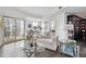Cozy living room with floor to ceiling windows, modern decor, and access to a private balcony at 300 W 11Th Ave # 15C, Denver, CO 80204