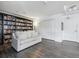 Living room featuring a full bookcase wall and hardwood flooring, perfect for reading and relaxing at 300 W 11Th Ave # 15C, Denver, CO 80204