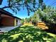 Expansive backyard featuring a lush lawn, privacy fence, and mature trees providing ample shade at 2900 S Adams St, Denver, CO 80210