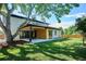 Backyard features a covered patio, an expansive lawn, and mature shade trees at 2900 S Adams St, Denver, CO 80210
