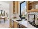 Wet bar with stylish cabinetry, marble countertop, wine cooler, and window views at 2900 S Adams St, Denver, CO 80210