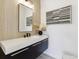 Stylish powder room with a modern vanity, elegant mirror, and chic decorative accents at 2900 S Adams St, Denver, CO 80210