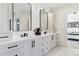 Luxurious bathroom with double vanity, modern fixtures, white marble floors, and custom cabinets at 2900 S Adams St, Denver, CO 80210
