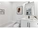 Contemporary bathroom with white subway tile, sleek fixtures, modern vanity, and stylish geometric art at 2900 S Adams St, Denver, CO 80210