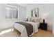 Minimalist bedroom with a large window, neutral decor, and modern bedside lamps on the nightstands at 2900 S Adams St, Denver, CO 80210