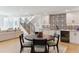 Dining area featuring a round table, modern chairs, open to the staircase, kitchen with patterned backsplash at 2900 S Adams St, Denver, CO 80210