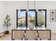 Elegant dining room with modern lighting and large windows offering a view of the backyard at 2900 S Adams St, Denver, CO 80210