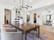 Spacious dining room featuring a modern chandelier, neutral colors, and seamless access to multiple rooms at 2900 S Adams St, Denver, CO 80210
