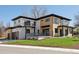 Modern home showcasing a unique two-tone design with a well-manicured lawn and a visible garage at 2900 S Adams St, Denver, CO 80210