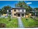Modern two-story home with wood and stucco exterior, professional landscaping, and inviting walkway at 2900 S Adams St, Denver, CO 80210