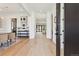 Inviting hallway with light wood floors, modern art, and a view leading to a bright living area at 2900 S Adams St, Denver, CO 80210