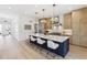 Bright kitchen with island seating, modern cabinets, stainless steel appliances, and stylish pendant lights at 2900 S Adams St, Denver, CO 80210