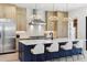 Bright kitchen with island seating, modern cabinets, stainless steel appliances, and stylish pendant lights at 2900 S Adams St, Denver, CO 80210