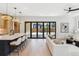 Open-concept living area connecting a modern kitchen with seamless access to the backyard through large glass doors at 2900 S Adams St, Denver, CO 80210