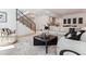 Open-concept living room with modern furniture, a staircase, and a glimpse of the kitchen at 2900 S Adams St, Denver, CO 80210