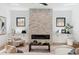Cozy living room with a stone fireplace, built-in cabinets, and comfortable seating at 2900 S Adams St, Denver, CO 80210